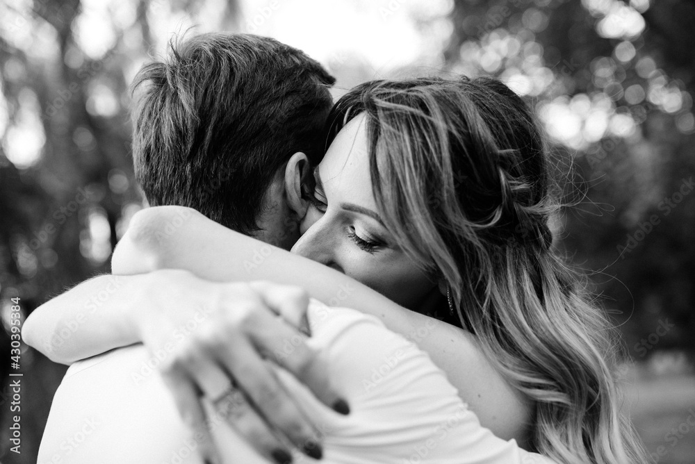 a guy and a girl are walking along the banks of a wild river overgrow