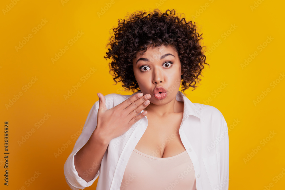 Surprised happy young woman face in excitement palm cove lips look camera posing on yellow wall Surprised happy young woman face in excitement palm cove lips look camera posing on yellow wall