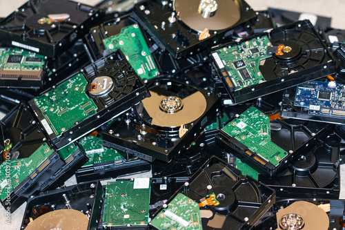 many computer hard drives are in a heap for disposal photo