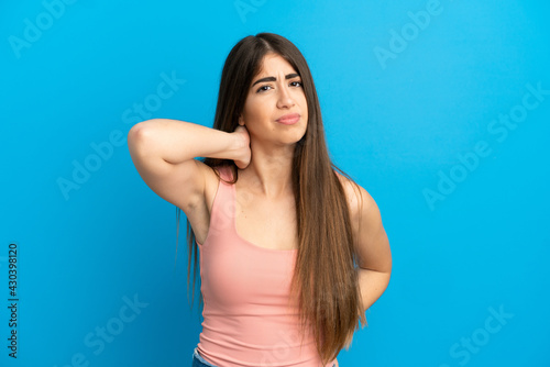 Young caucasian woman isolated on blue background with neckache