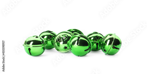 Shiny green sleigh bells on white background