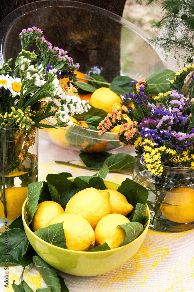 A plate with lemons among wildflowers (Festival of lemons)