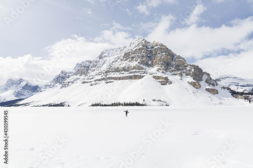Walking in snow beside the rocky mountain
