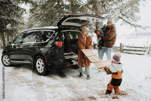 Canada, Ontario, Family with children unpacking car trunk