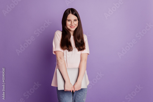 Photo of girl with laptop posing on purple background