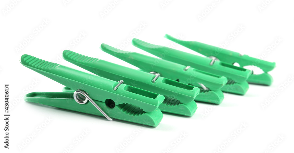 Bright green plastic clothespins on white background Bright green plastic clothespins on white background