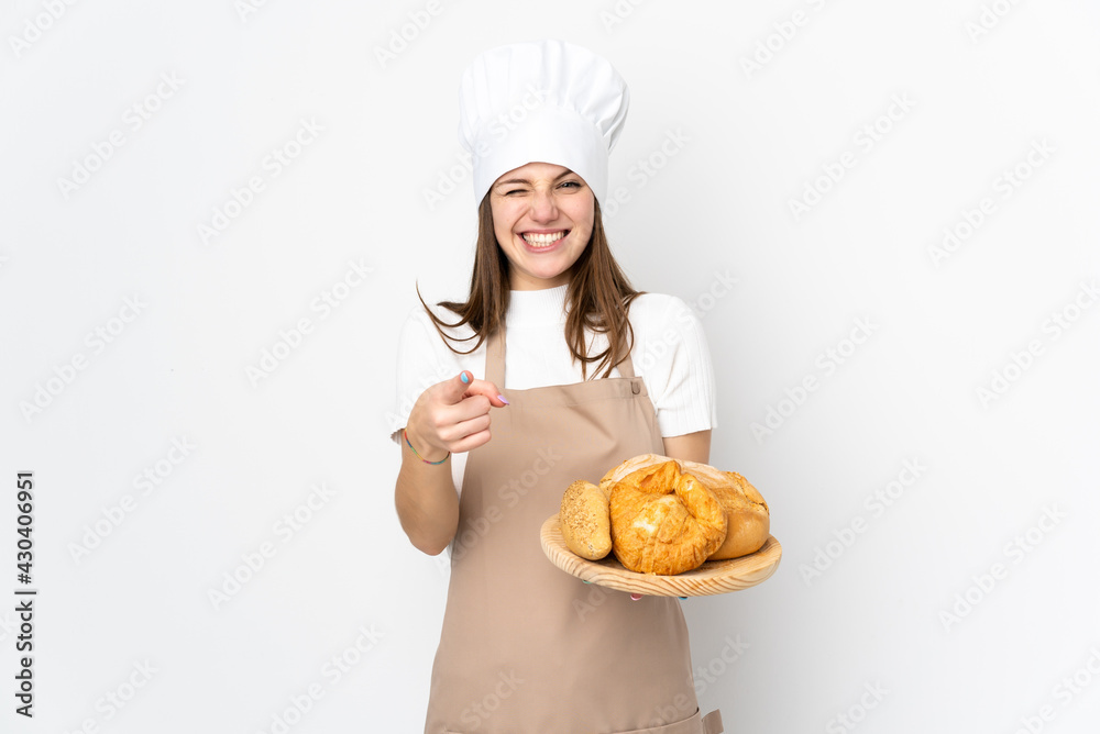 Young woman in chef uniform isolated on white background points finger at you Young woman in chef uniform isolated on white background points finger at you