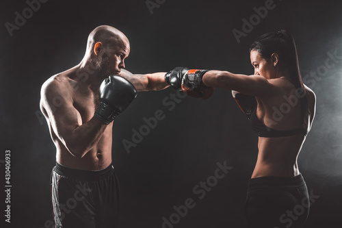Shirtless Woman exercising with trainer at boxing and self defen © zamuruev