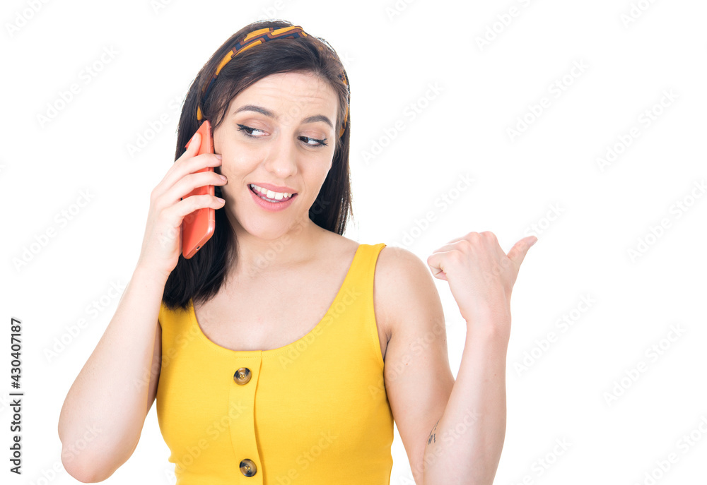 Pleased young woman talks on the smartphone, isolated on white background. Happy girl using the smart phone Pleased young woman talks on the smartphone, isolated on white background. Happy girl using the smart phone