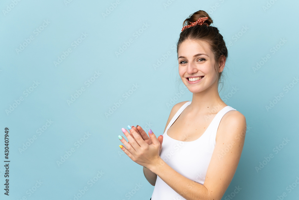 Young caucasian woman isolated on blue background applauding Young caucasian woman isolated on blue background applauding