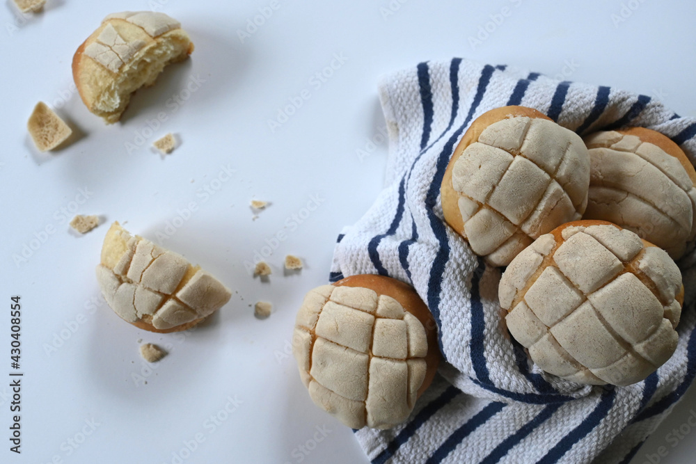 closeup of delicious homemade Mexican vanilla shells with white and blue cotton cloth on white surface