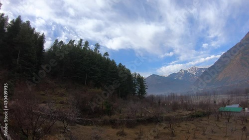 4K Time lapse shot of the clouds above the snow covered mountains at Manali, Himchal Pradesh, India photo