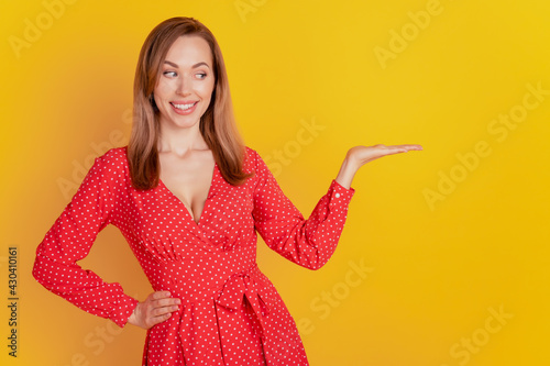 Portrait of funny promoter woman holding copyspace on palm