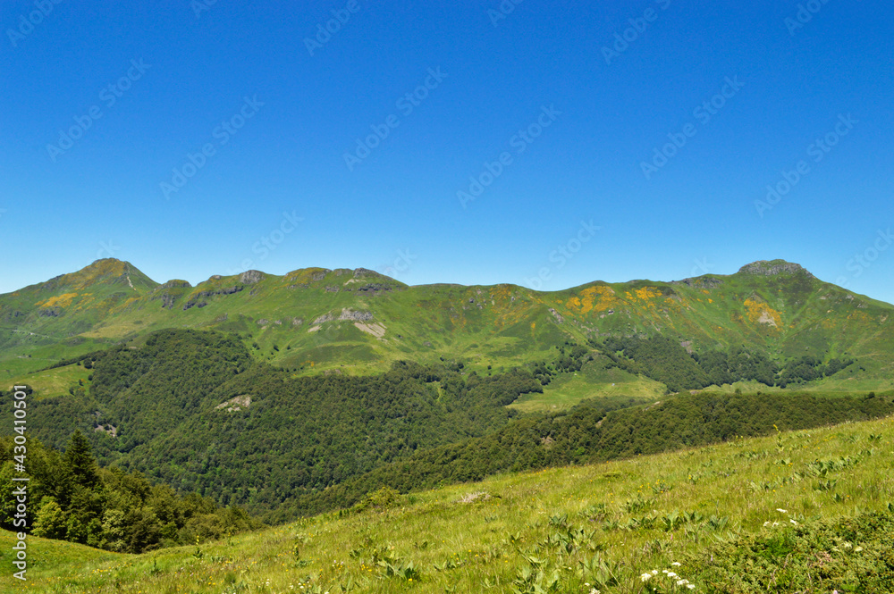 Magnificent view of a panorama of volcanic mountains in a national park in a wild region, in Auvergne Magnificent view of a panorama of volcanic mountains in a national park in a wild region, in Auvergne