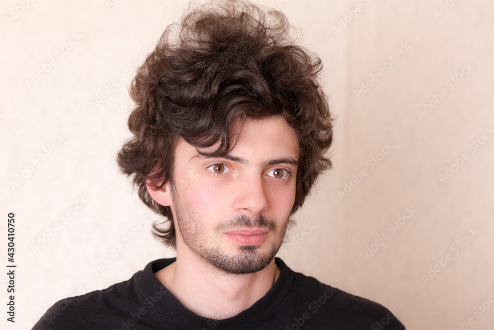 studio portrait of a curly haired man studio portrait of a curly haired man