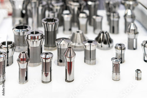 Various many type and size spring steel collet chuck for cnc machining center or automatic milling machine on table photo