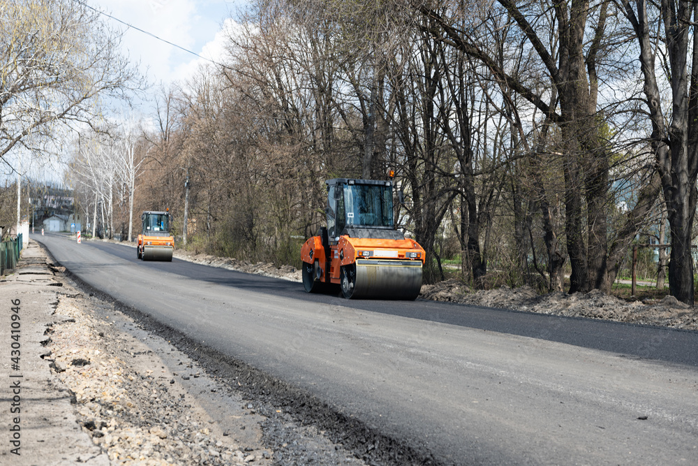 road repair with new asphalt and road rollers