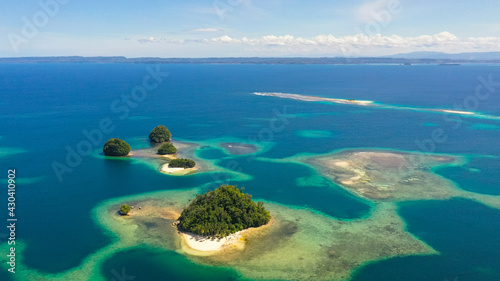 Aerial view of sandy beach on a tropical island with palm trees. Britania Islands, Surigao del Sur, Philippines.
