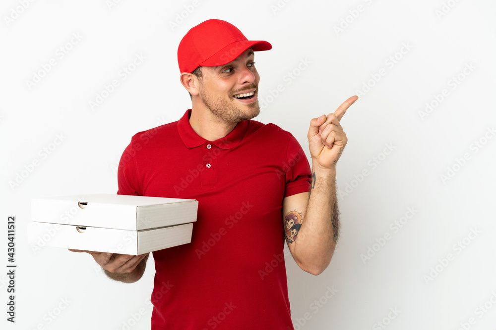 pizza delivery man with work uniform picking up pizza boxes over isolated white wall intending to realizes the solution while lifting a finger up pizza delivery man with work uniform picking up pizza boxes over isolated white wall intending to realizes the solution while lifting a finger up