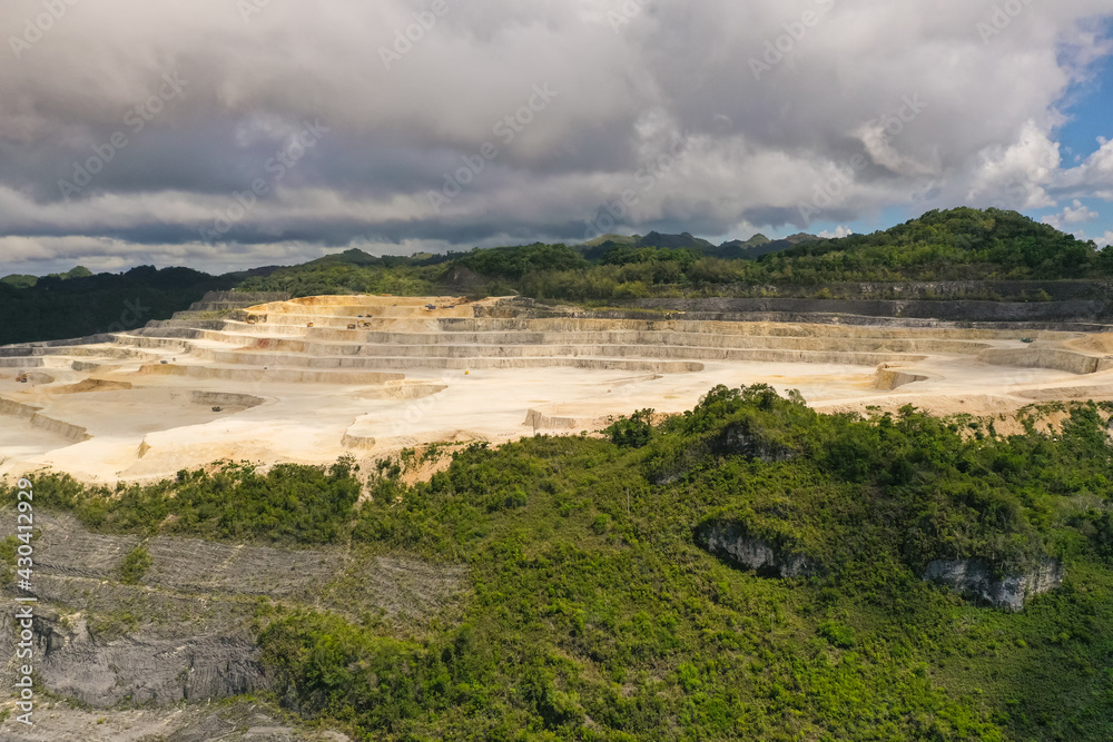 Open pit limestone quarry in the mountains of Bohol Island, Philippines. limestone quarry view from above.