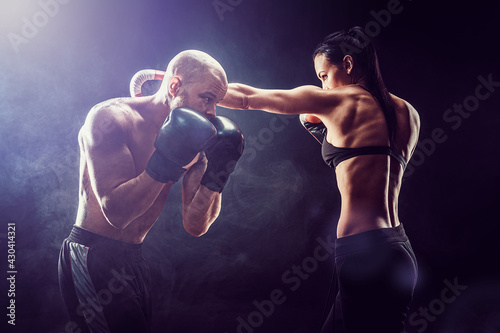 Shirtless Woman exercising with trainer at boxing and self defen © zamuruev