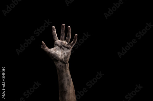 scary zombie hand isolated on black with dirty fingernails.
