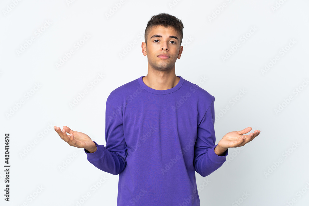 Young brazilian man isolated on white background having doubts Young brazilian man isolated on white background having doubts