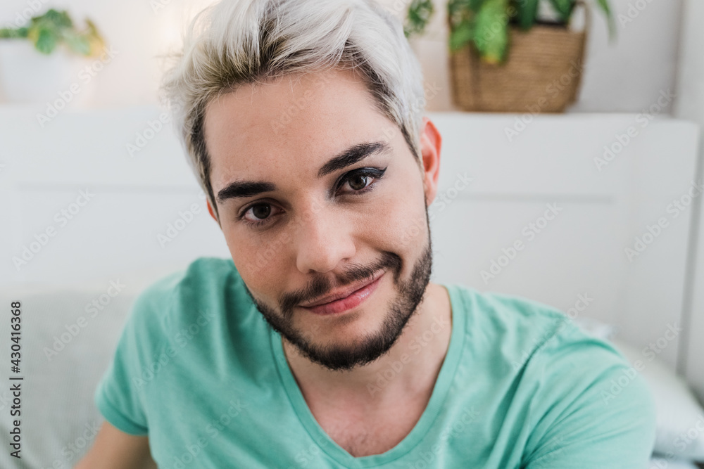 Drag queen looking at camera indoors at home - Focus on face Drag queen looking at camera indoors at home - Focus on face