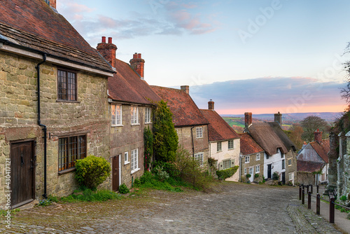 Sunset over cottages on a cobbled street photo