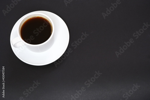 Black coffee  on a black background.
