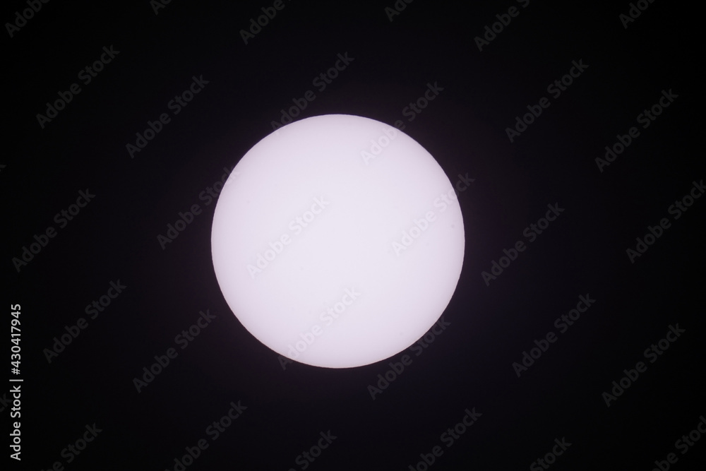 Detailed Close up telephoto of the sun in the sky taken using a super telephoto lens. Shoot from East Java Indonesia 3 April 2021 1.44 pm.