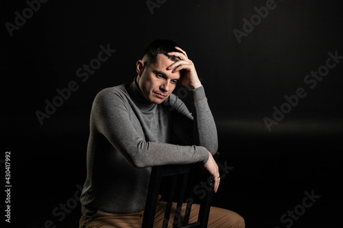 Man sits and thinks in frustration