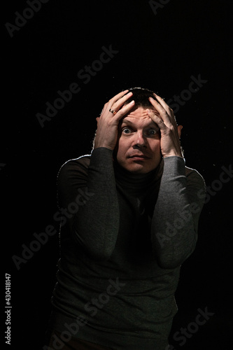 Man in panic grabbed his head and goggled