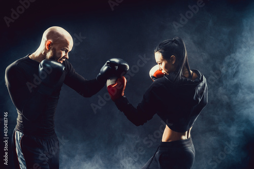 Woman exercising with trainer at boxing and self defense lesson © zamuruev