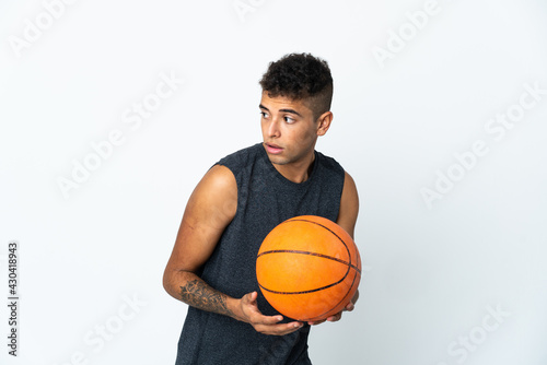 Young Brazilian man over isolated background playing basketball © luismolinero