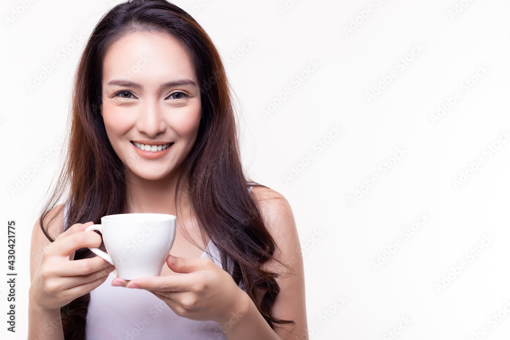 Woman drink hot coffee and hold coffee cup with smile face and happy in morning Beautiful girl drinking hot herbal tea and enjoy drinking it She stand over isolated on white background copy space Woman drink hot coffee and hold coffee cup with smile face and happy in morning Beautiful girl drinking hot herbal tea and enjoy drinking it She stand over isolated on white background copy space