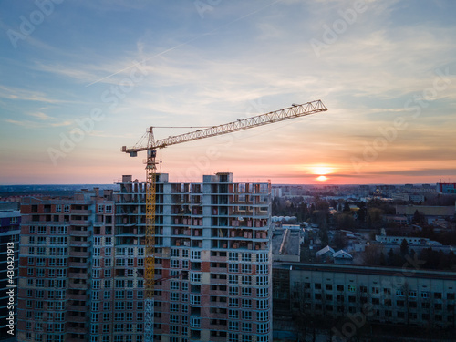 aerial view of apartment construction site with crane