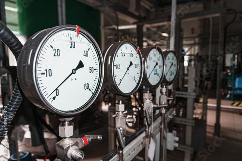 Pressure gauge is a close-up pressure measuring device in a row.