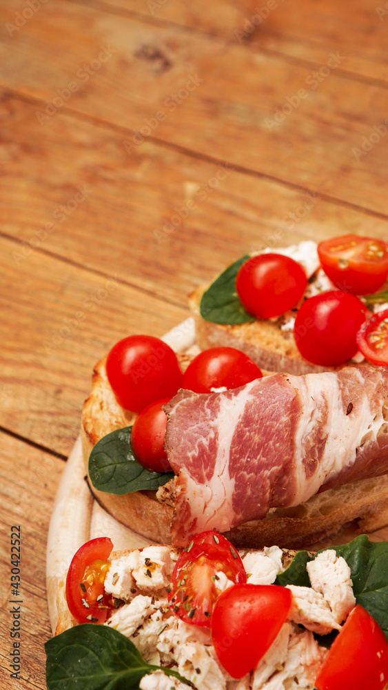 Italian appetizer. Bruschetta on a wooden board on a wooden rustic background Italian appetizer. Bruschetta on a wooden board on a wooden rustic background
