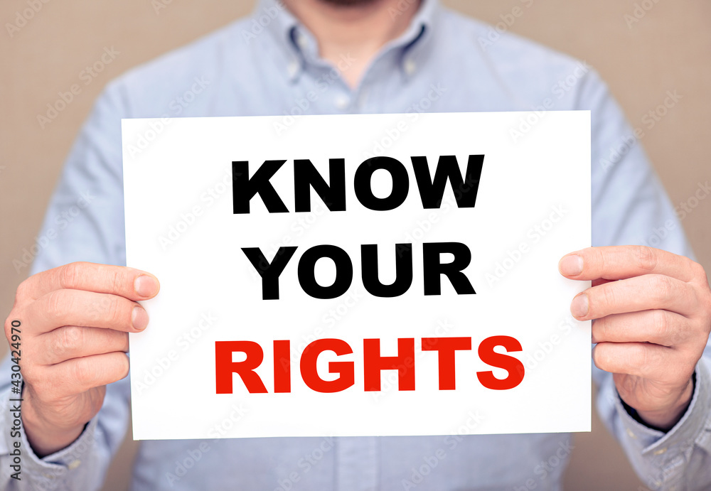 A man businessman holding white sheet with text Know Your Rights A man businessman holding white sheet with text Know Your Rights