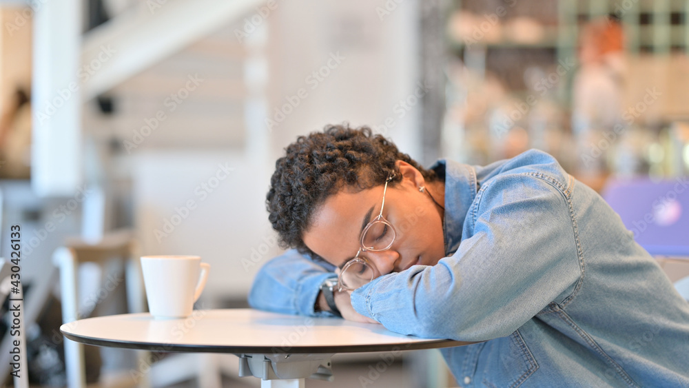 Exhausted African Woman taking Nap in Cafe Exhausted African Woman taking Nap in Cafe