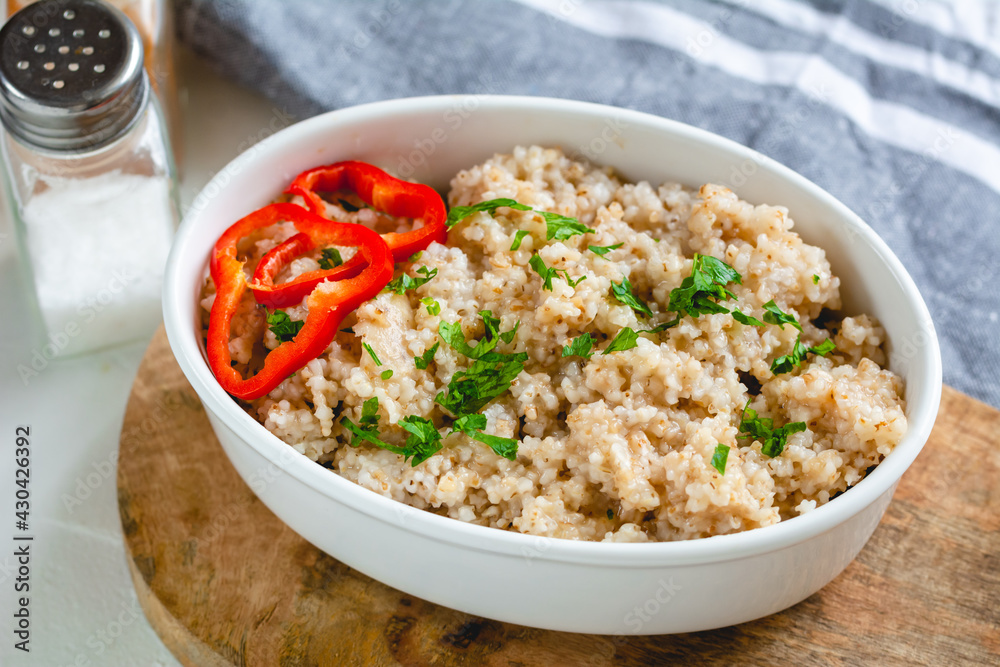 Cooked barley grains in a white bowl. Healthy food Cooked barley grains in a white bowl. Healthy food