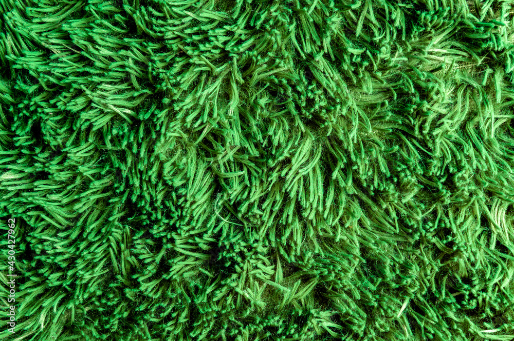 Artificial green grass texture. Background top-view close-up. Gress background