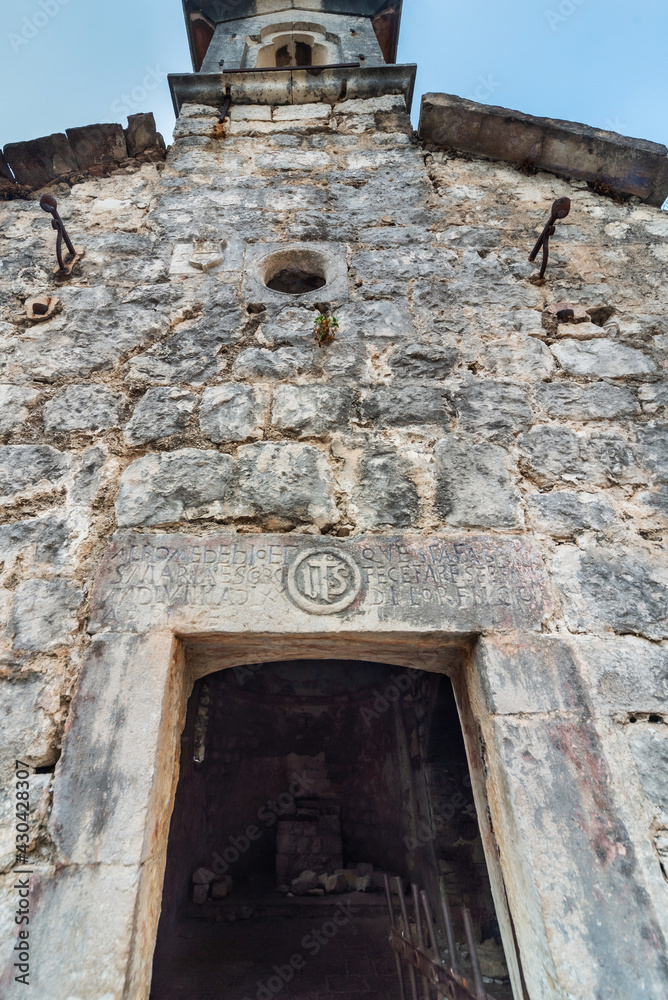 1000 year old doorway of the church of St John,looking up to the bell tower, Kotor,Montenegro.