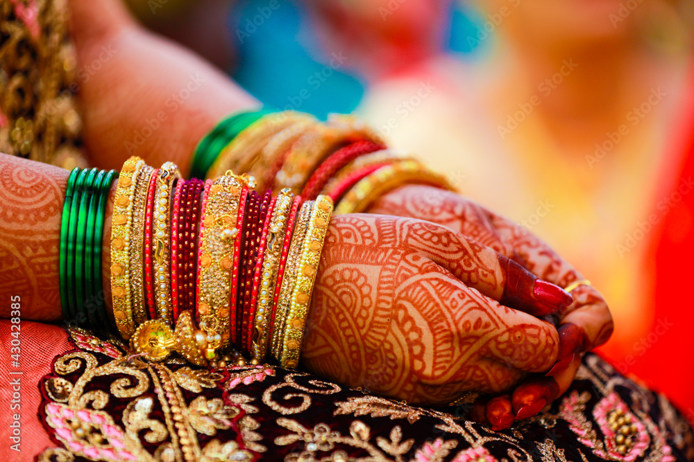 Hands of bride is decorated beautifully by indian mehndi art along with jewelery’s and colorful bangles Hands of bride is decorated beautifully by indian mehndi art along with jewelery’s and colorful bangles