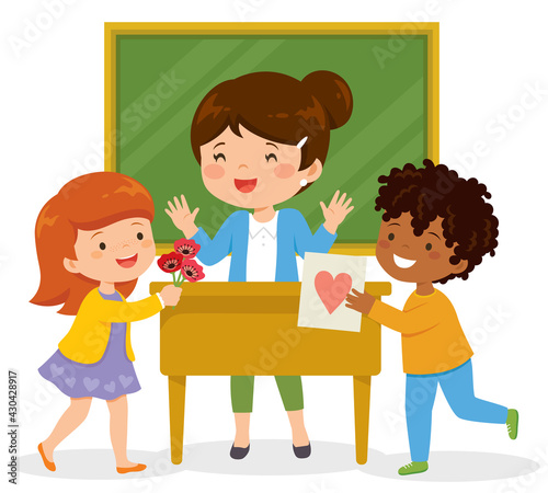 Kids loving their teacher. Young school children showing appreciation to their teacher by giving her flowers and a card.