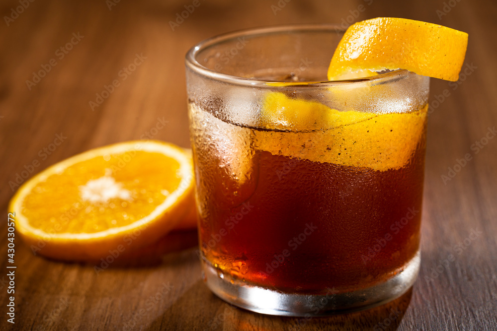 Negroni cocktail with orange, on wooden background. Negroni cocktail with orange, on wooden background.