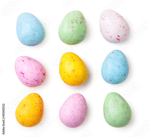 Valokuva Small speckled multicolored chocolate eggs set on a white background, isolated