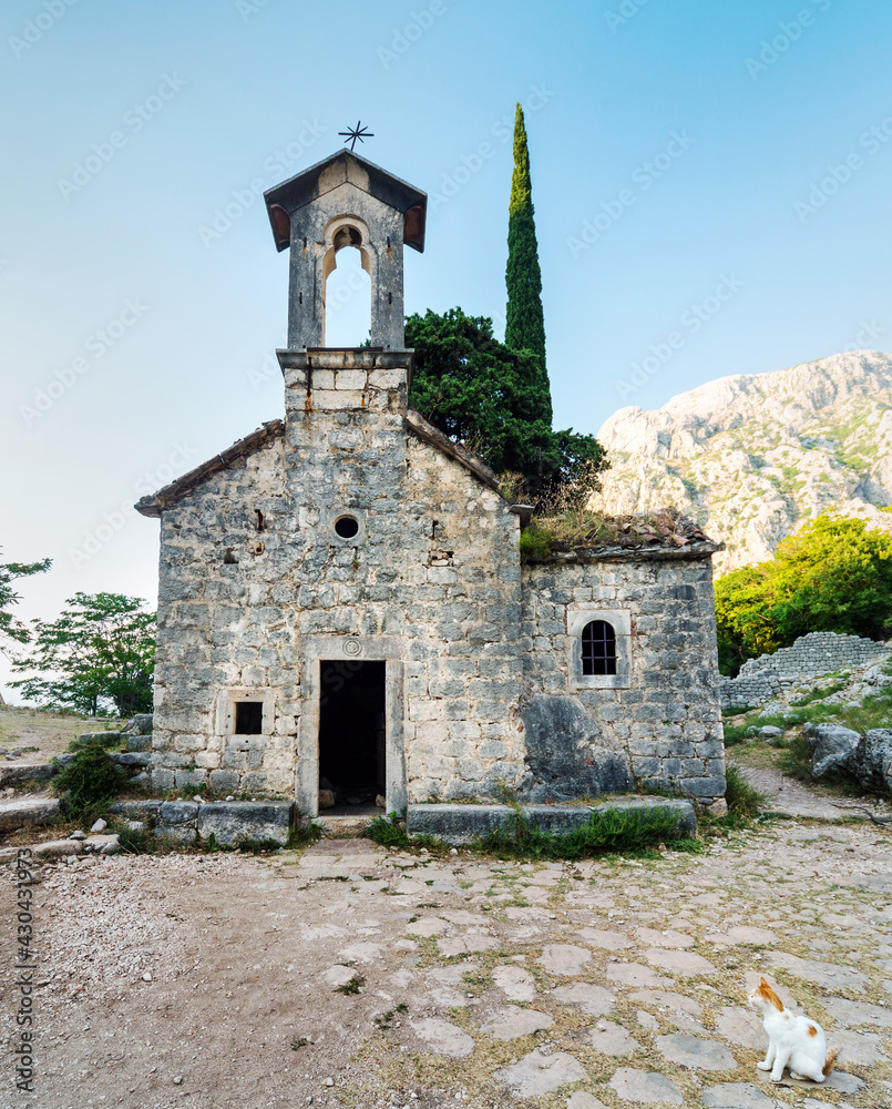 Church of Saint John and ancient courtyard,surrounded by beautiful rocky mountain scenery at sunset, Kotor,Montenegro.