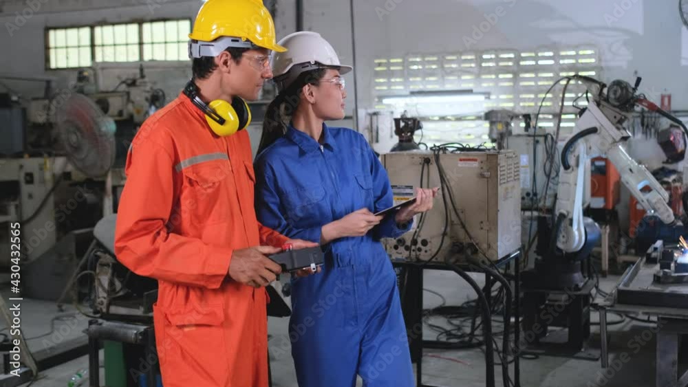 custom made wallpaper toronto digitalFactory workers man and woman or technician discuss about welding robot machine is working in workplace and they also hold tablet and controller.